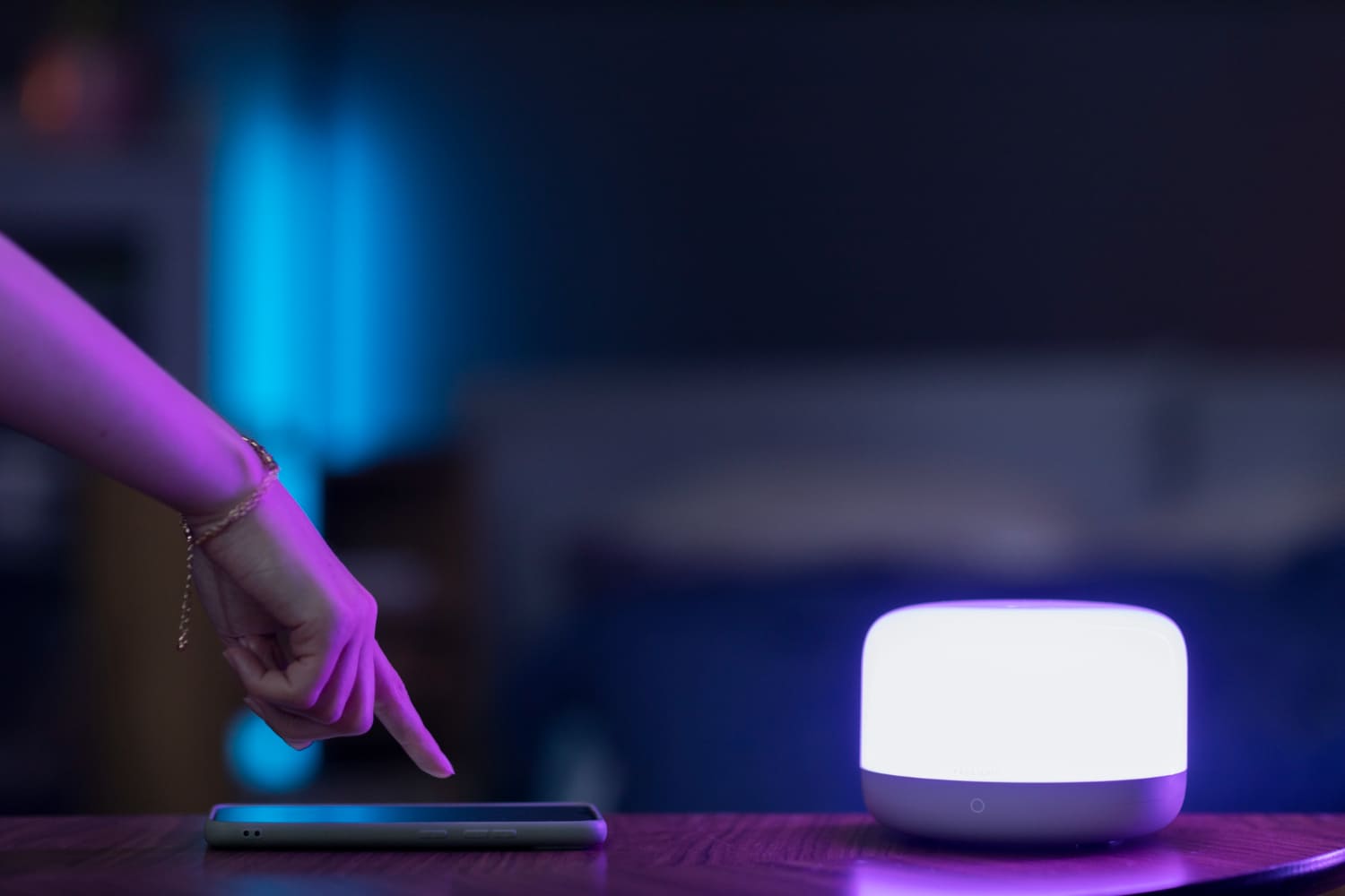 Billede af lampe med Smart pære og smartphone der tykker på appen